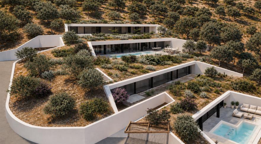 Aerial view of the two villas stepped into the hillside above the sea