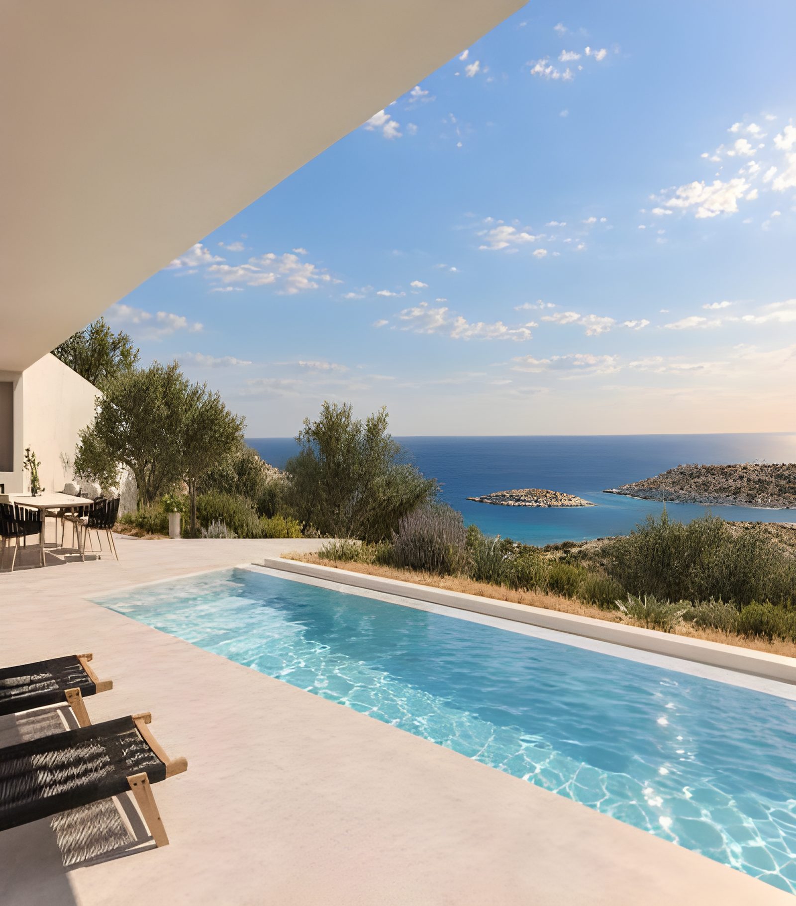Pool terrace with sun loungers and a view across the bay
