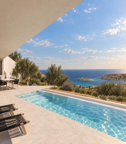 Pool terrace with sun loungers and a view across the bay